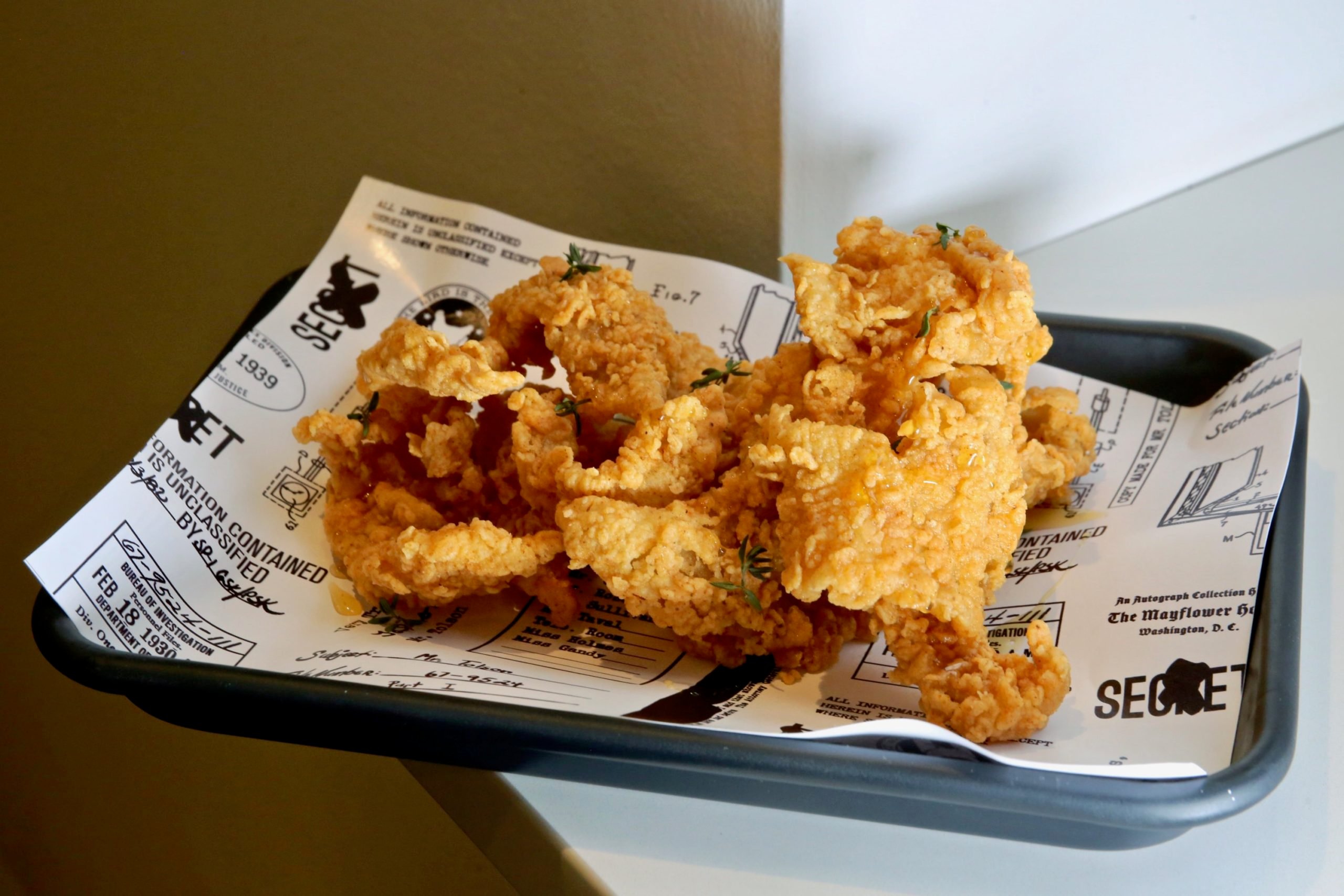 Tolson Bird Bar, Mayflower hotel - Washingtonian Crispy chicken skins with hot honey. Photograph by Evy Mages.