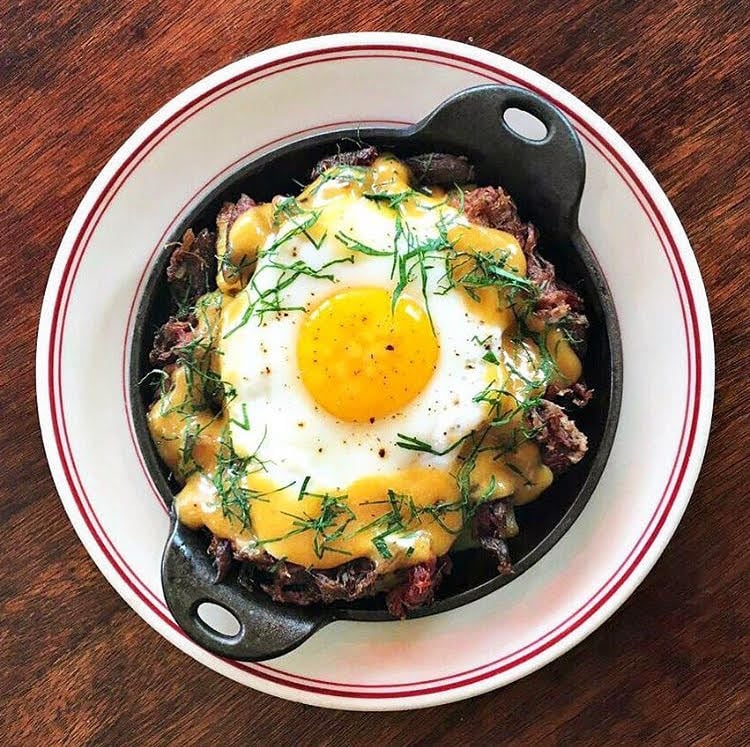 Duck Sarladaise Le Diplomate - Washingtonian Duck confit is topped with an egg at Le Diplomate. Photo courtesy of Le Diplomate.