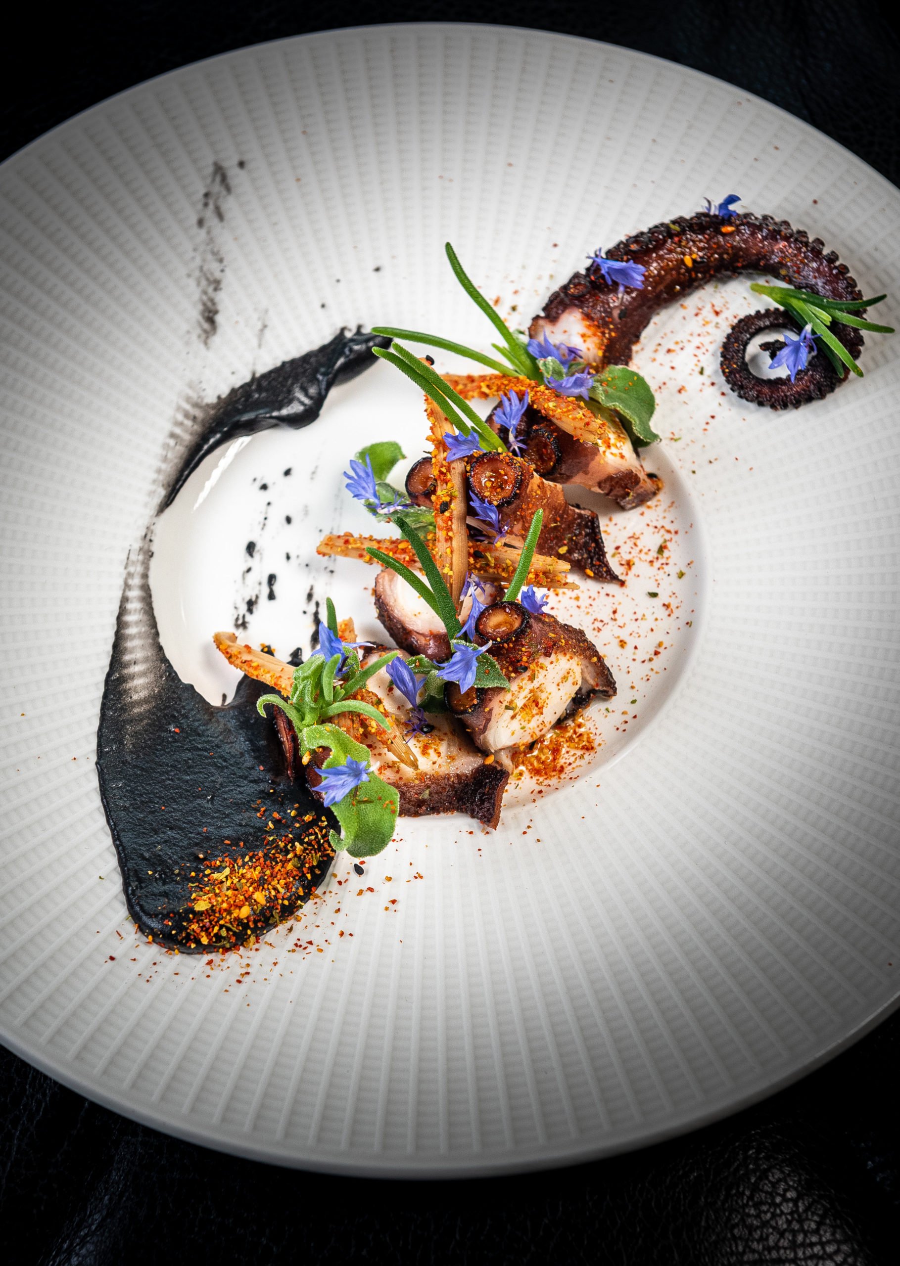 Octopus with smoked paprika oil and sake butter. Photo by Rey Lopez.