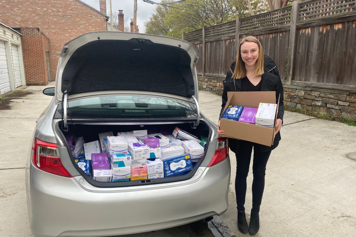 MedSupplyDrive founder Allison Rooney loads a car with PPE. Photo courtesy of MedSupplyDrive.