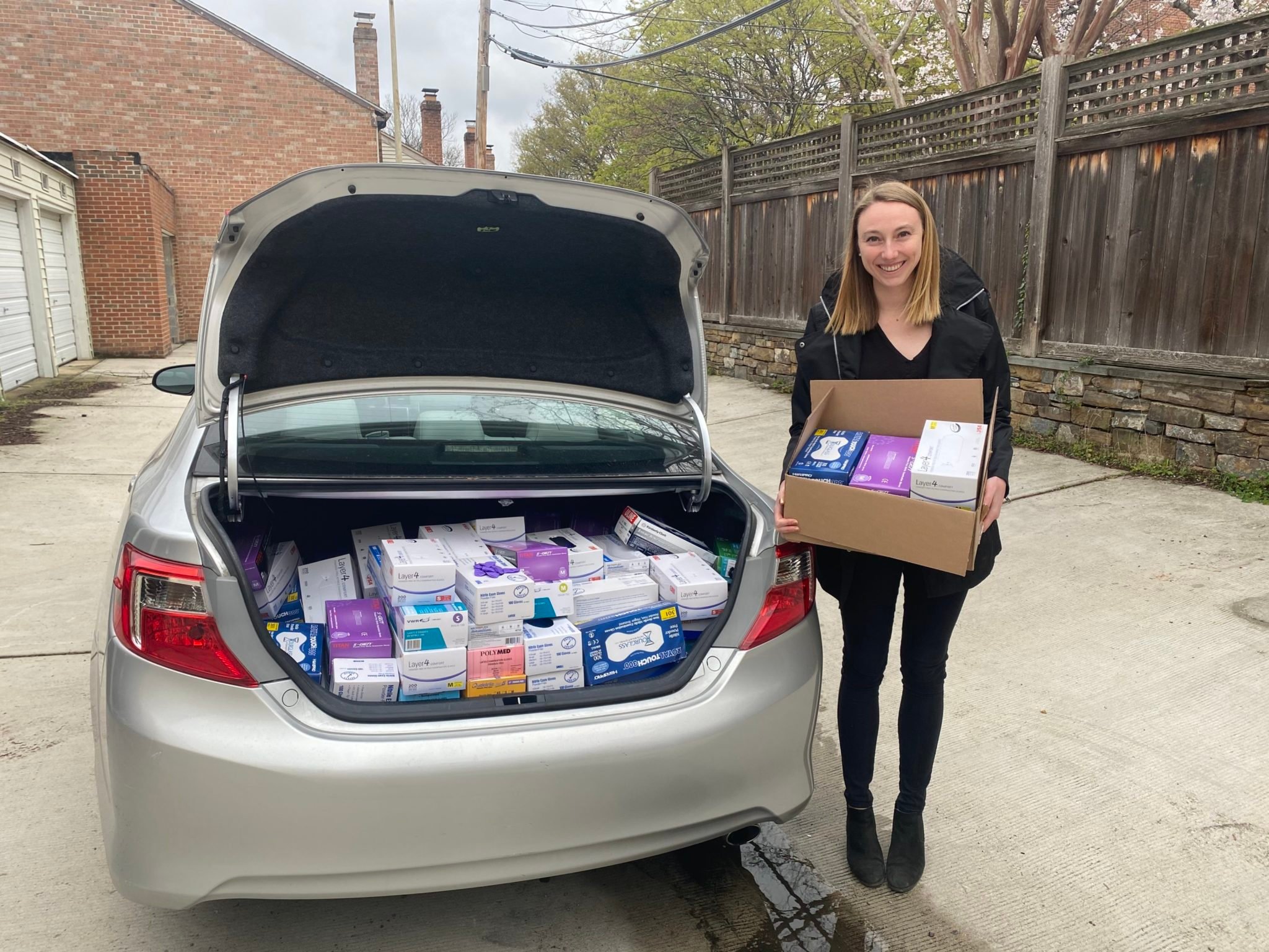 MedSupplyDrive founder Allison Rooney loads a car with PPE. Photo courtesy of MedSupplyDrive.