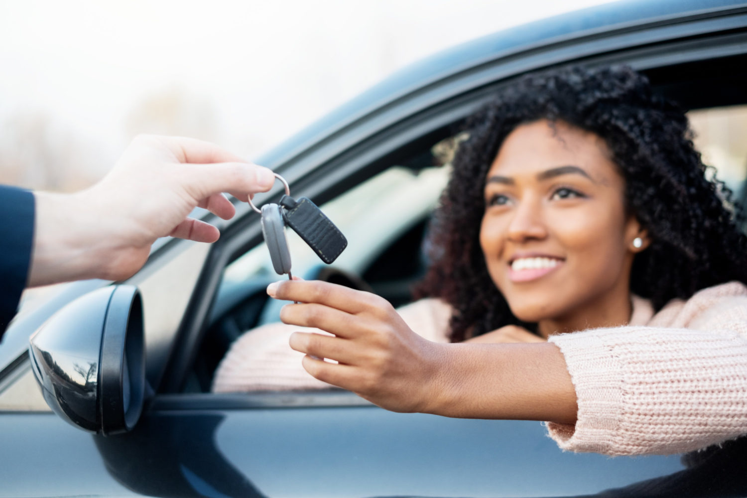 Happy black woman and her new car