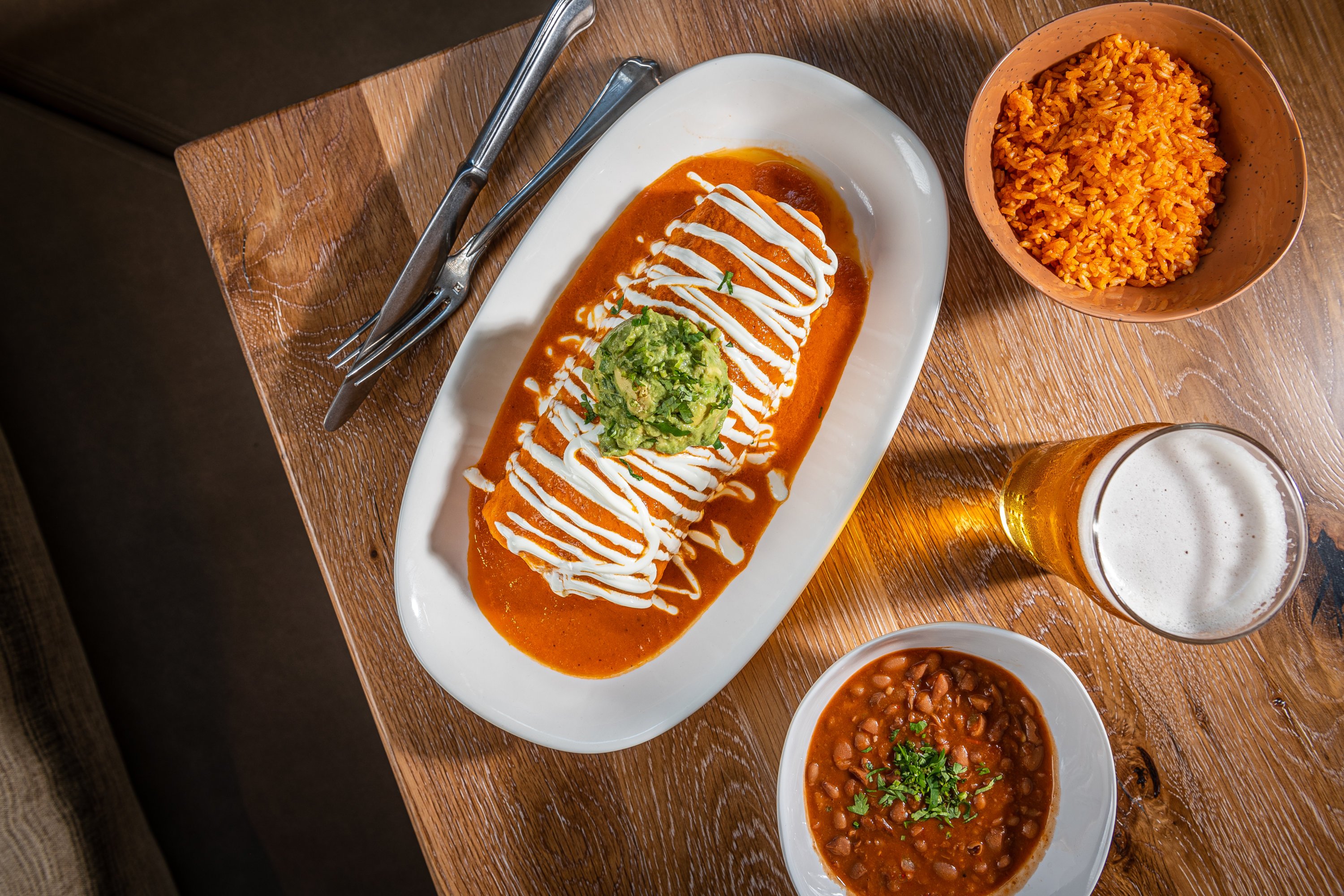 Burritos are layered with ranchero sauce. Photo by Rey Lopez. 