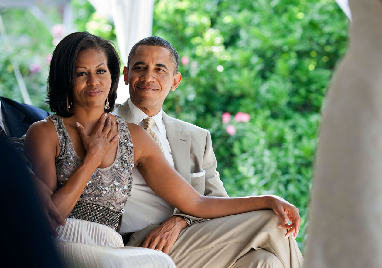 June 18, 2012 "The First Lady reacts as she watches Laura Jarrett and Tony Balkissoon take their vows during their wedding at Valerie Jarrett's home in Chicago." (Official White House Photo by Pete Souza) This official White House photograph is being made available only for publication by news organizations and/or for personal use printing by the subject(s) of the photograph. The photograph may not be manipulated in any way and may not be used in commercial or political materials, advertisements, emails, products, promotions that in any way suggests approval or endorsement of the President, the First Family, or the White House.