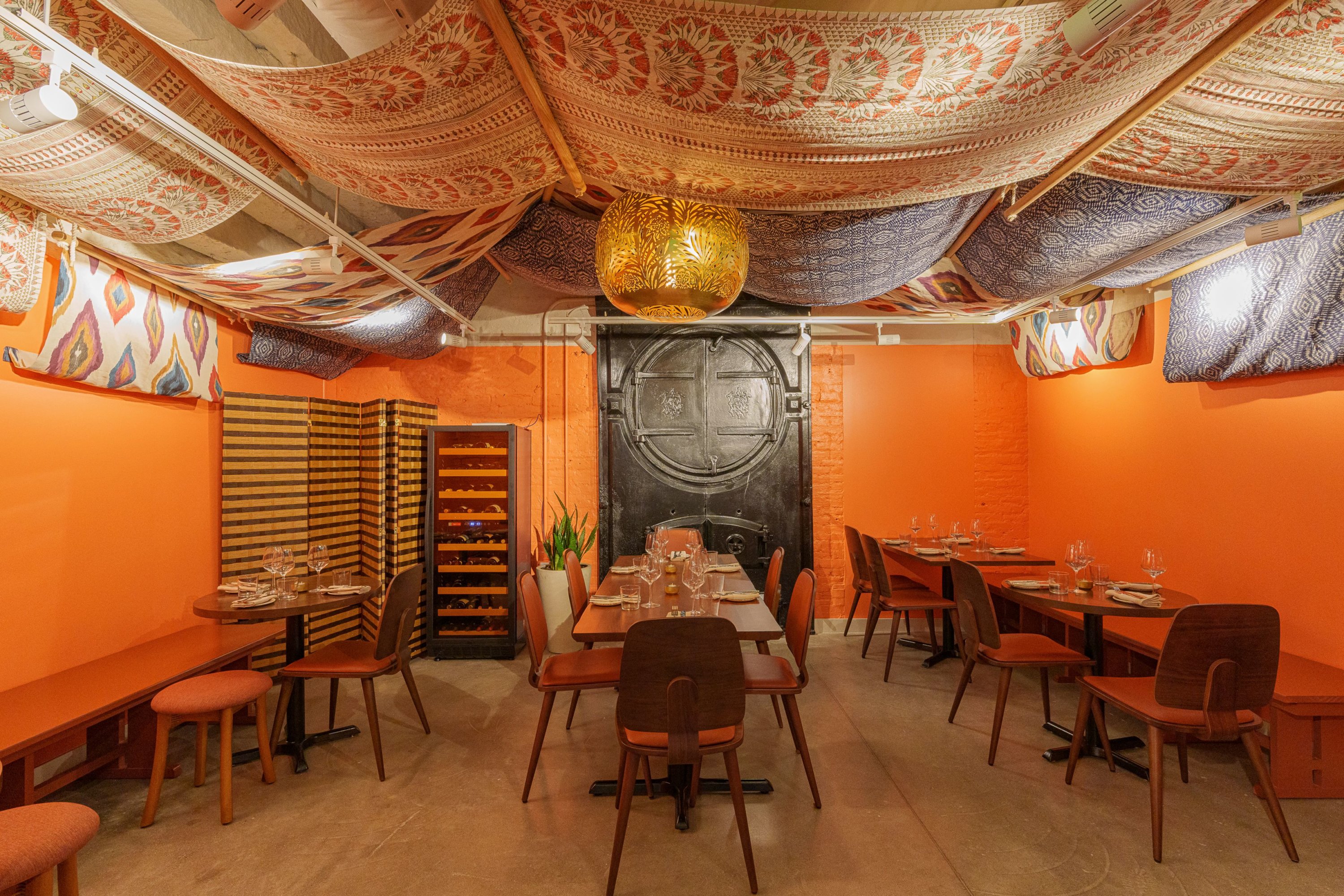 The dining space is draped with tapestries. Photo by Elizabeth Sanjuan Photography. 