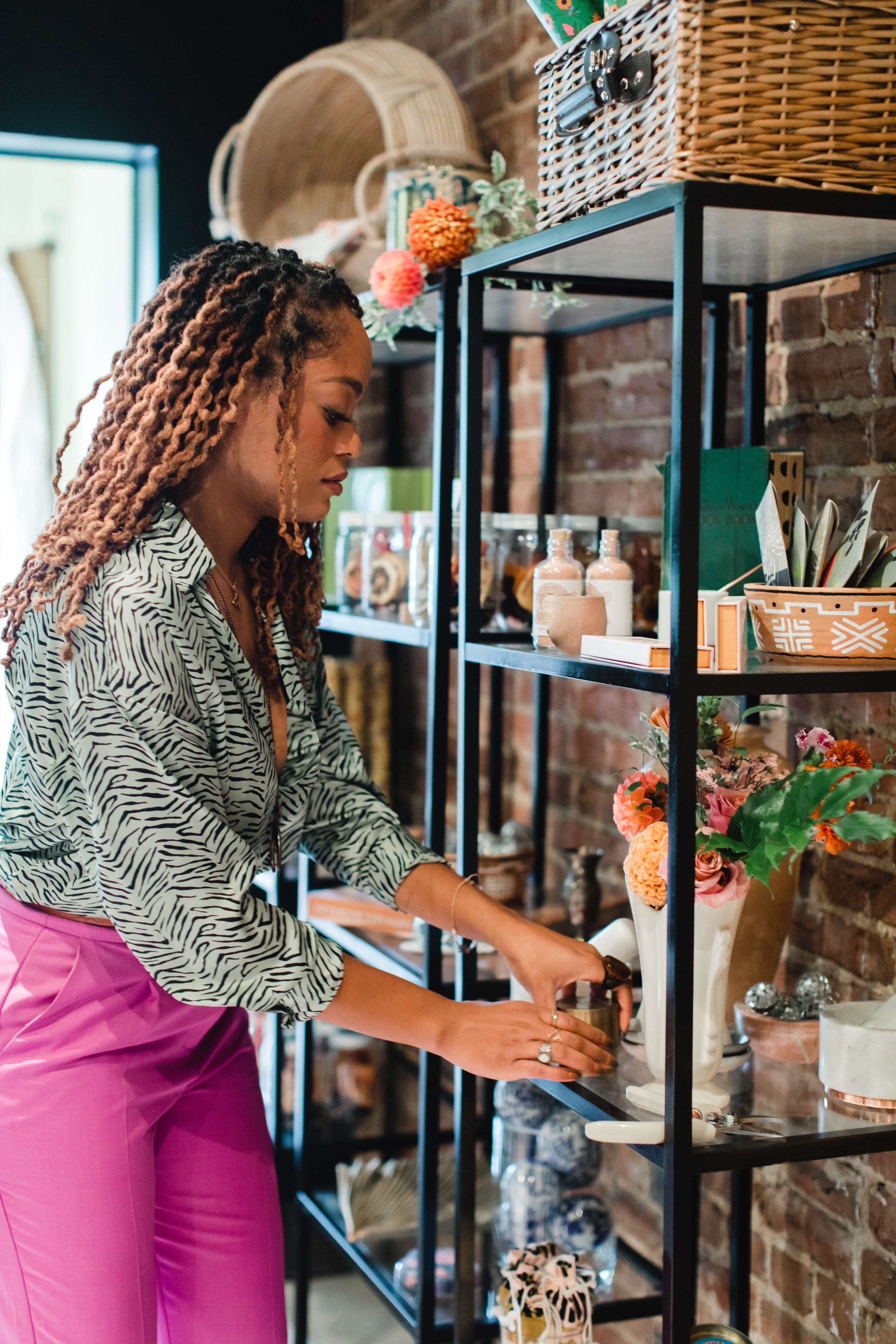 She Loves Me - Washingtonian Team member Blaire Bradford adjusts a shelf stocked with curated goods. Photo by Maddie Kaye Photo.