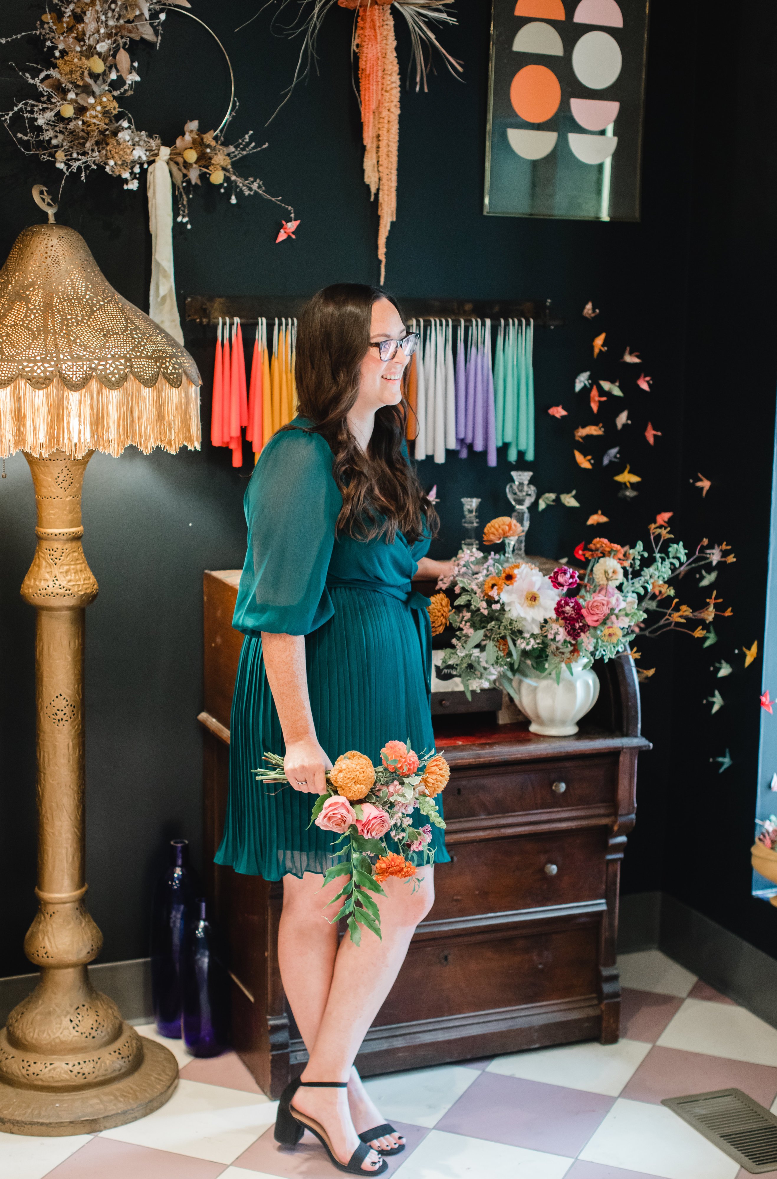 The store will mainly sell bouquets like the colorful arrangement held by team member Meredith Keegan. Photo by Maddie Kaye Photo. 