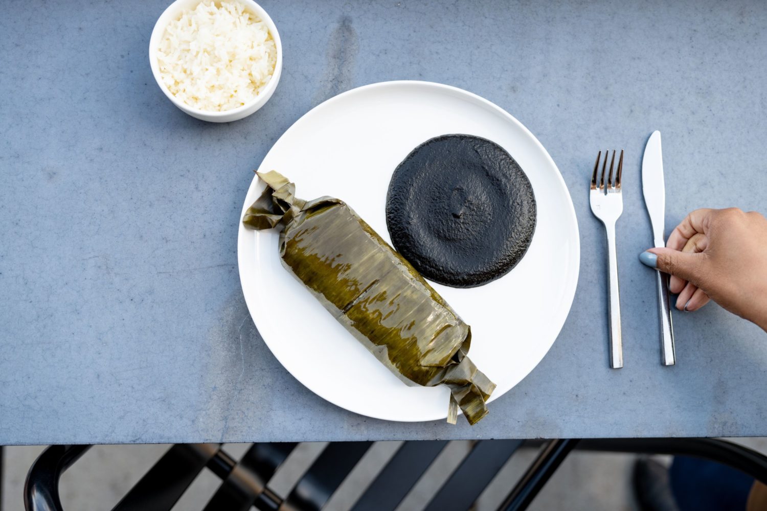 A braised beef tamales is paired with mole negro. Photo by Leah Judson.