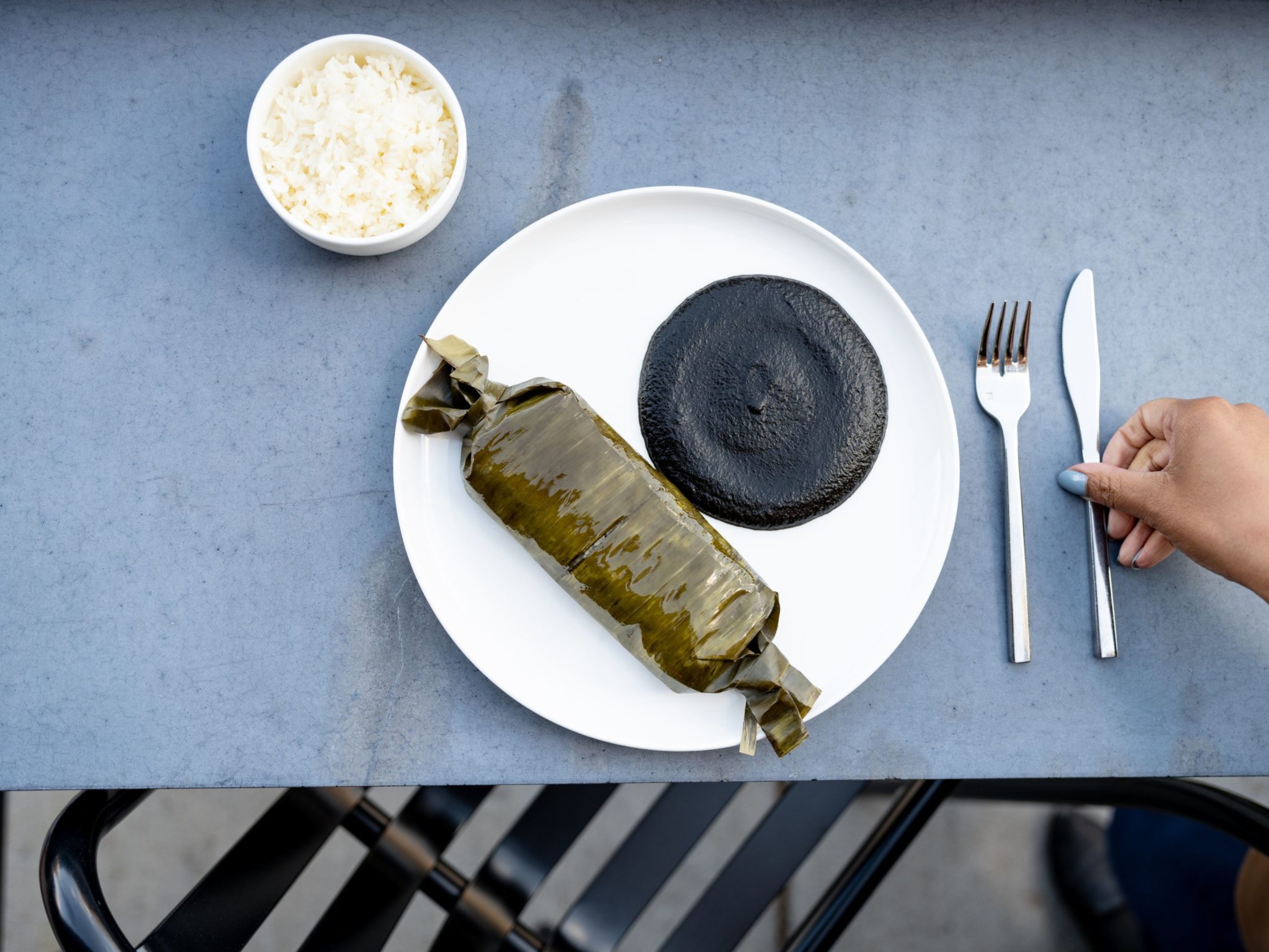 A braised beef tamales is paired with mole negro. Photo by Leah Judson.