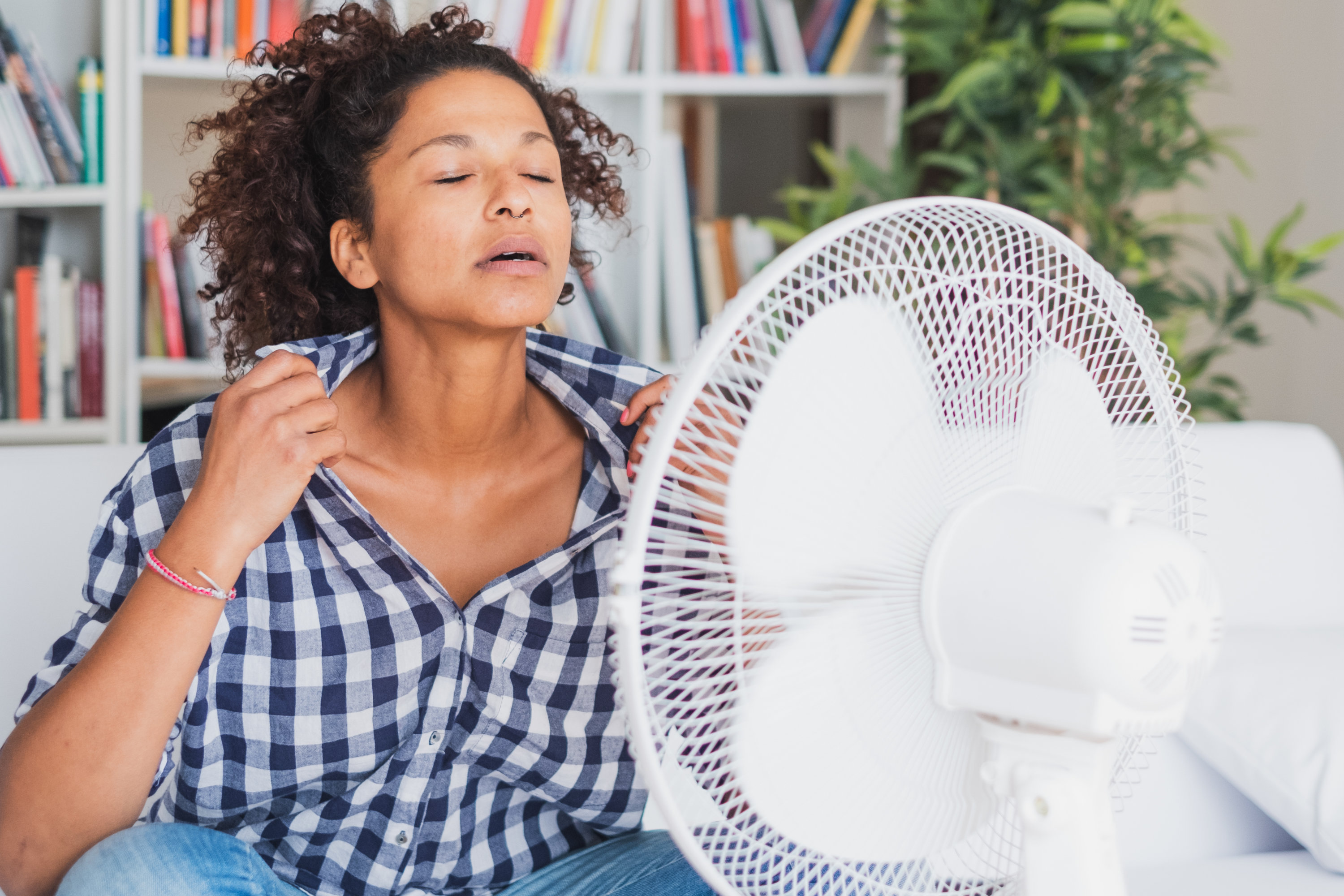 Black woman feeling hot and trying to refresh - Washingtonian