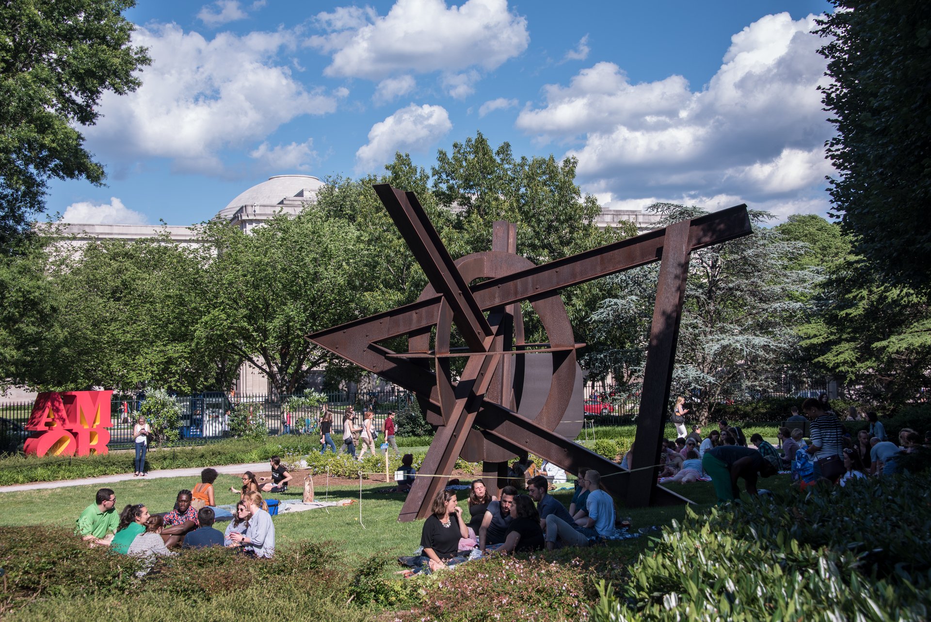 People sitting on picnic blankets in the National Gallery of Art's Sculpture Garden at Jazz in the Garden