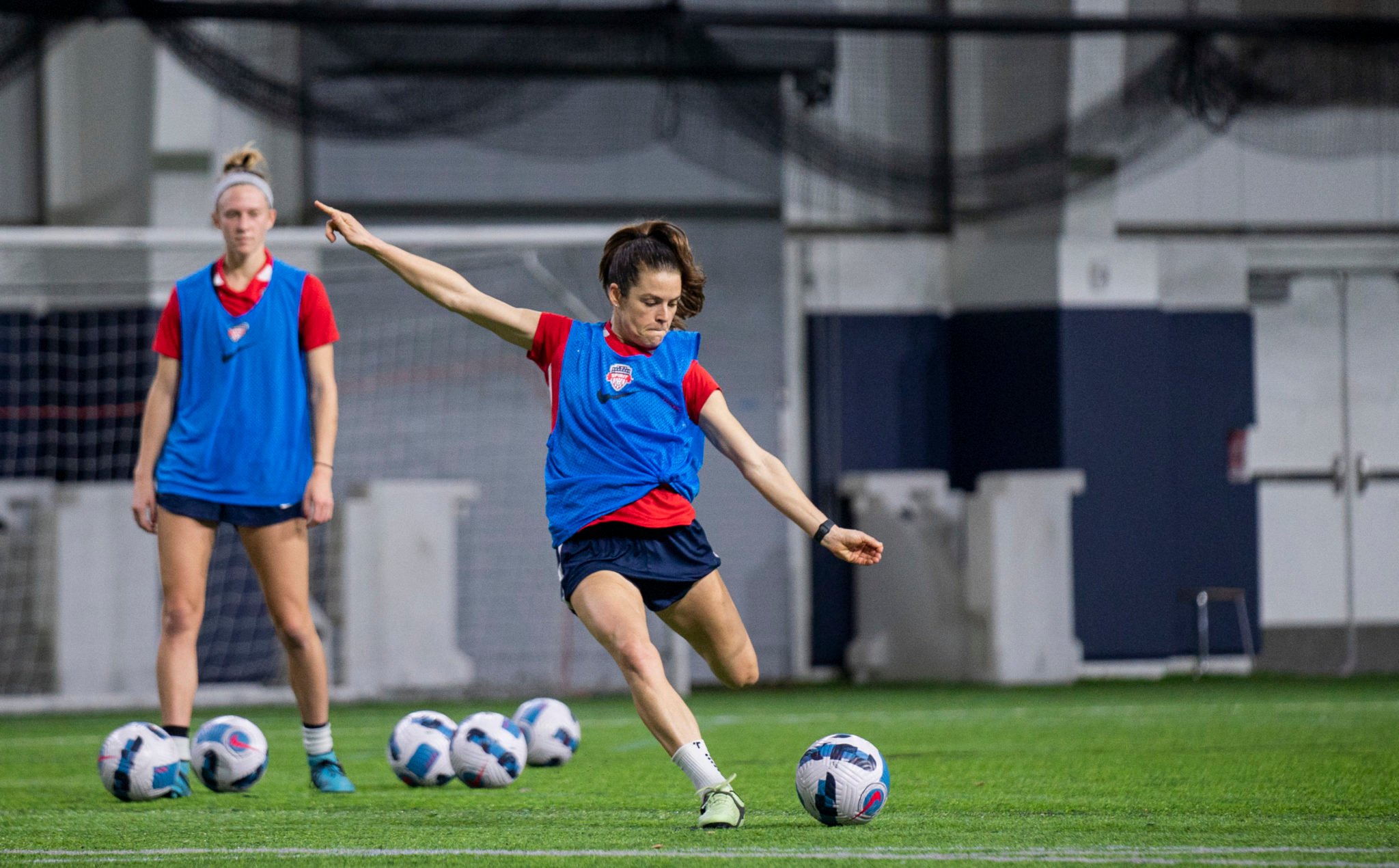 Kelley O'Hara kicking a ball during the 2022 Washington Spirit preseason.