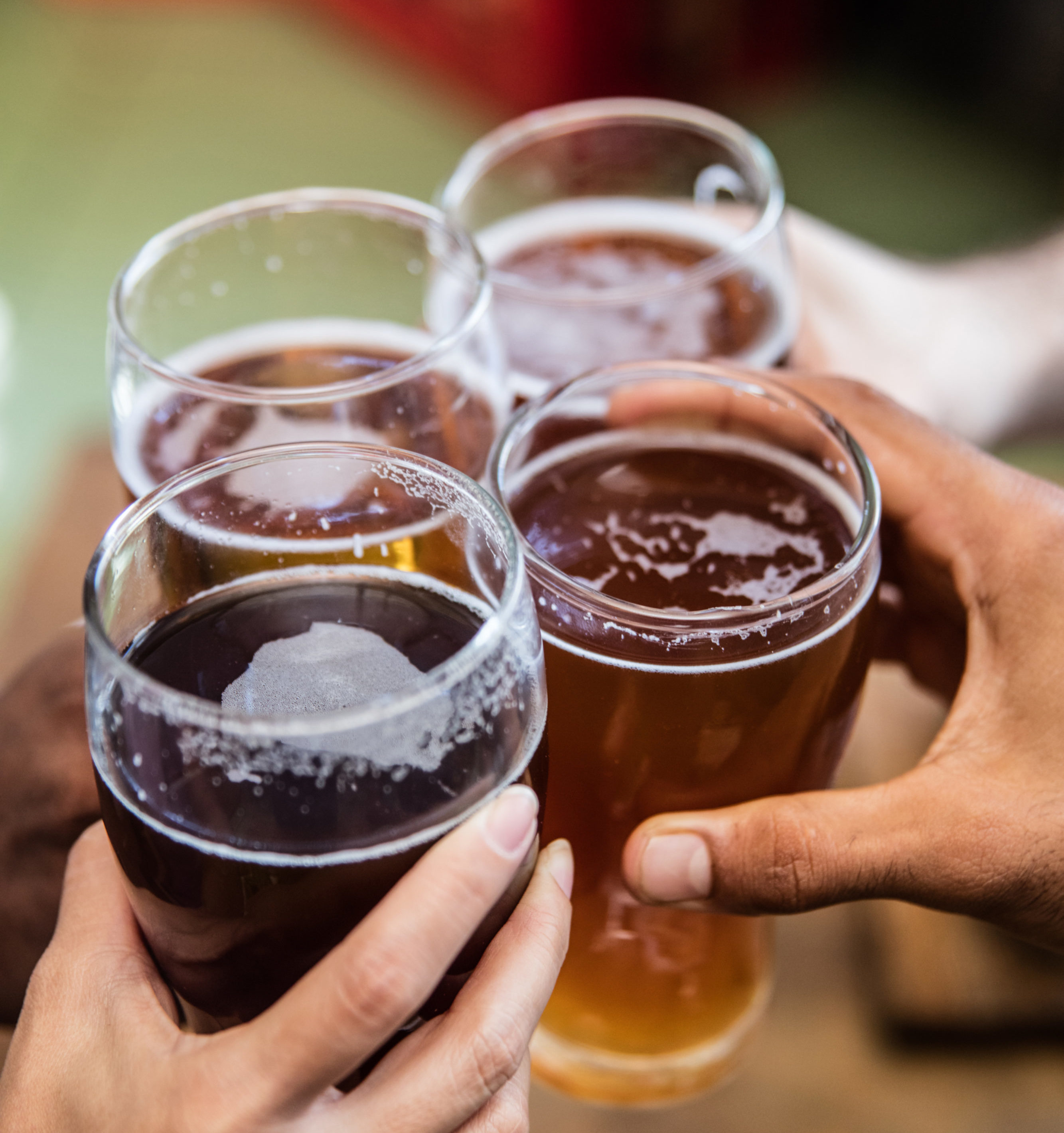 Friends having drinks at the bar and making a toast - Washingtonian Photo via iStock.