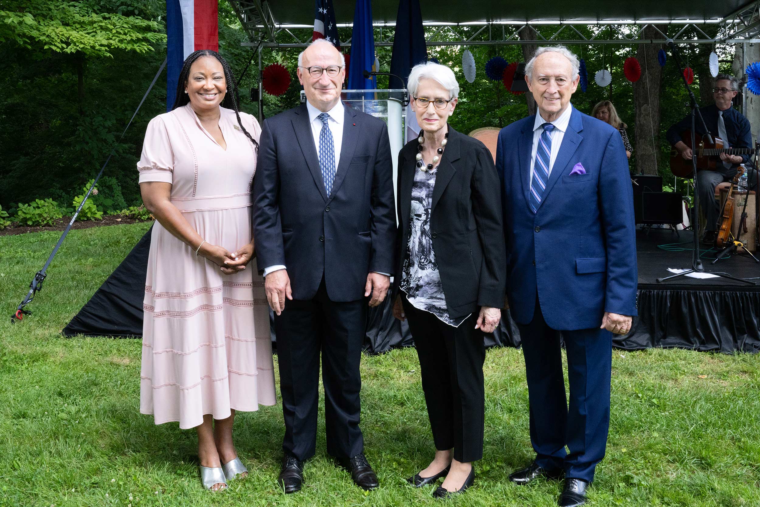 Two men and a women stand side by side.