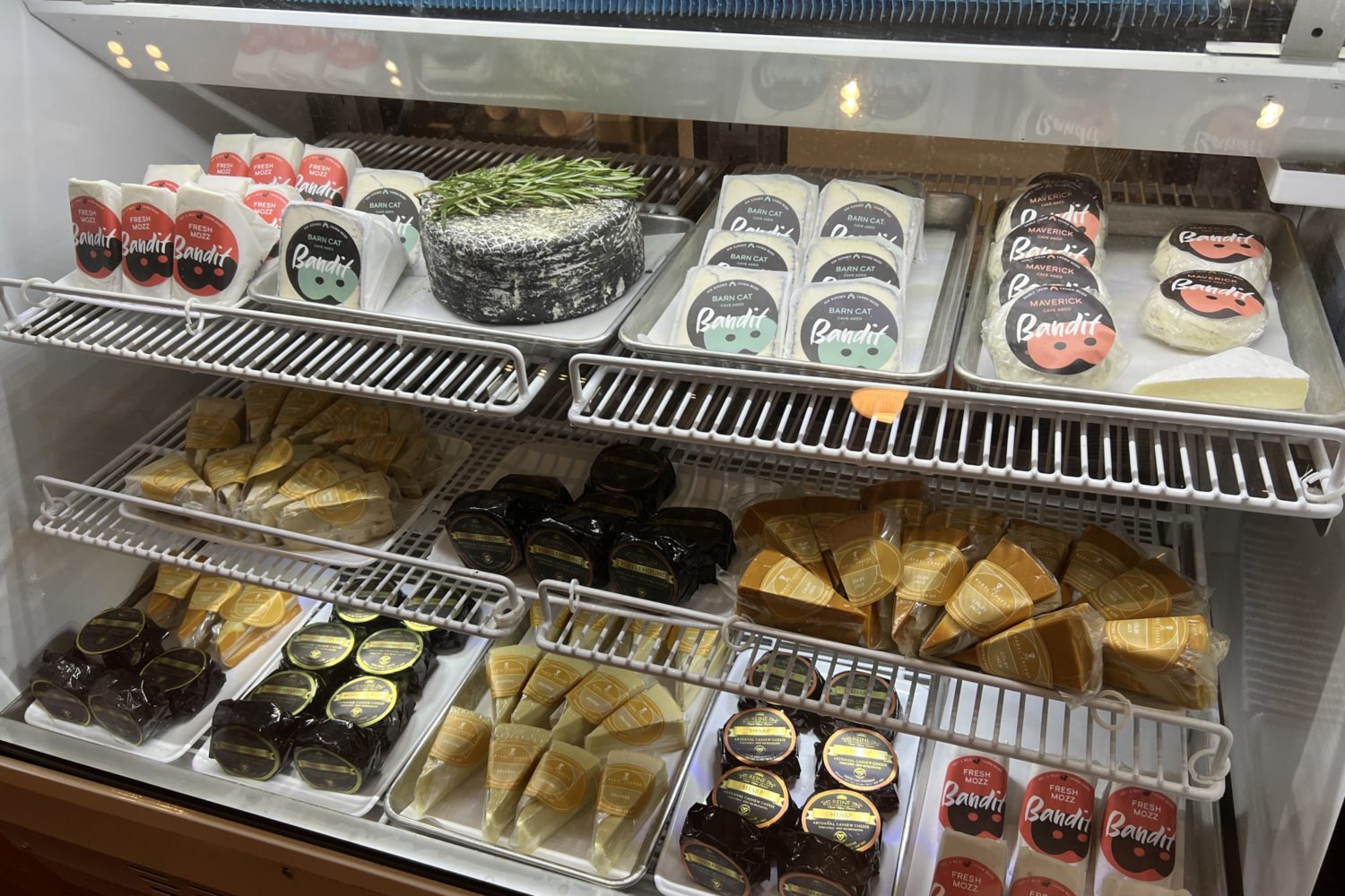 A deli counter with different varieties of vegan cheeses at DC Vegan
