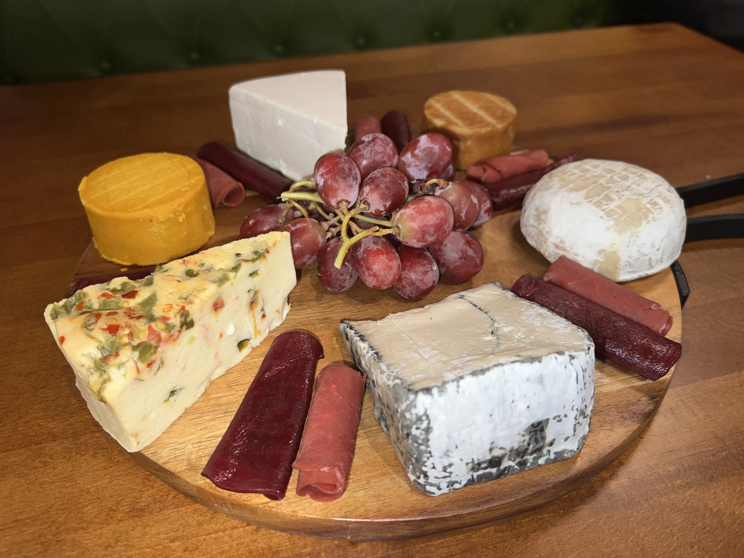 Six cheeses from DC Vegan's new selection on a cheese board