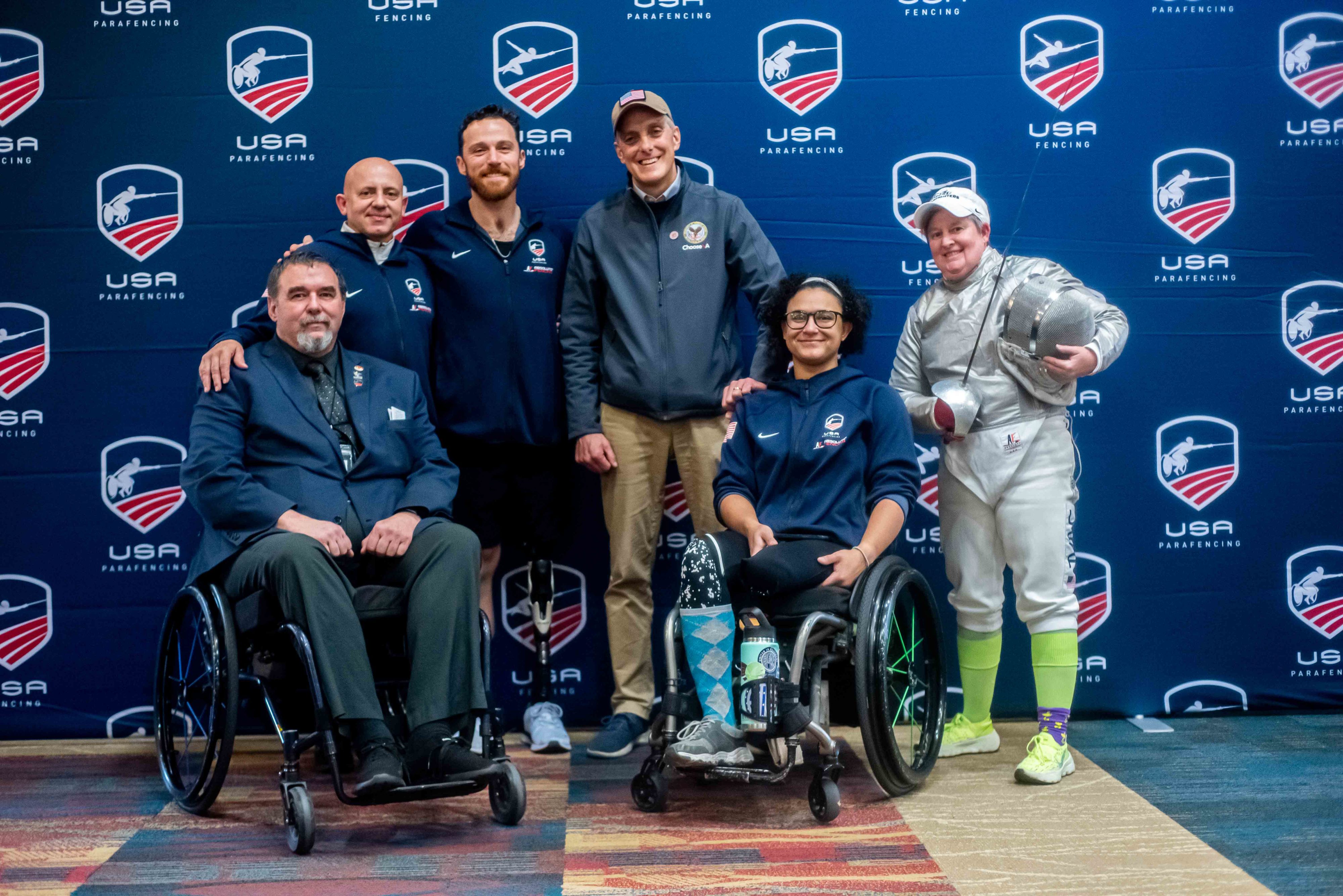 Secretary of Veteran Affairs Denis McDonough posing with veteran parafencers