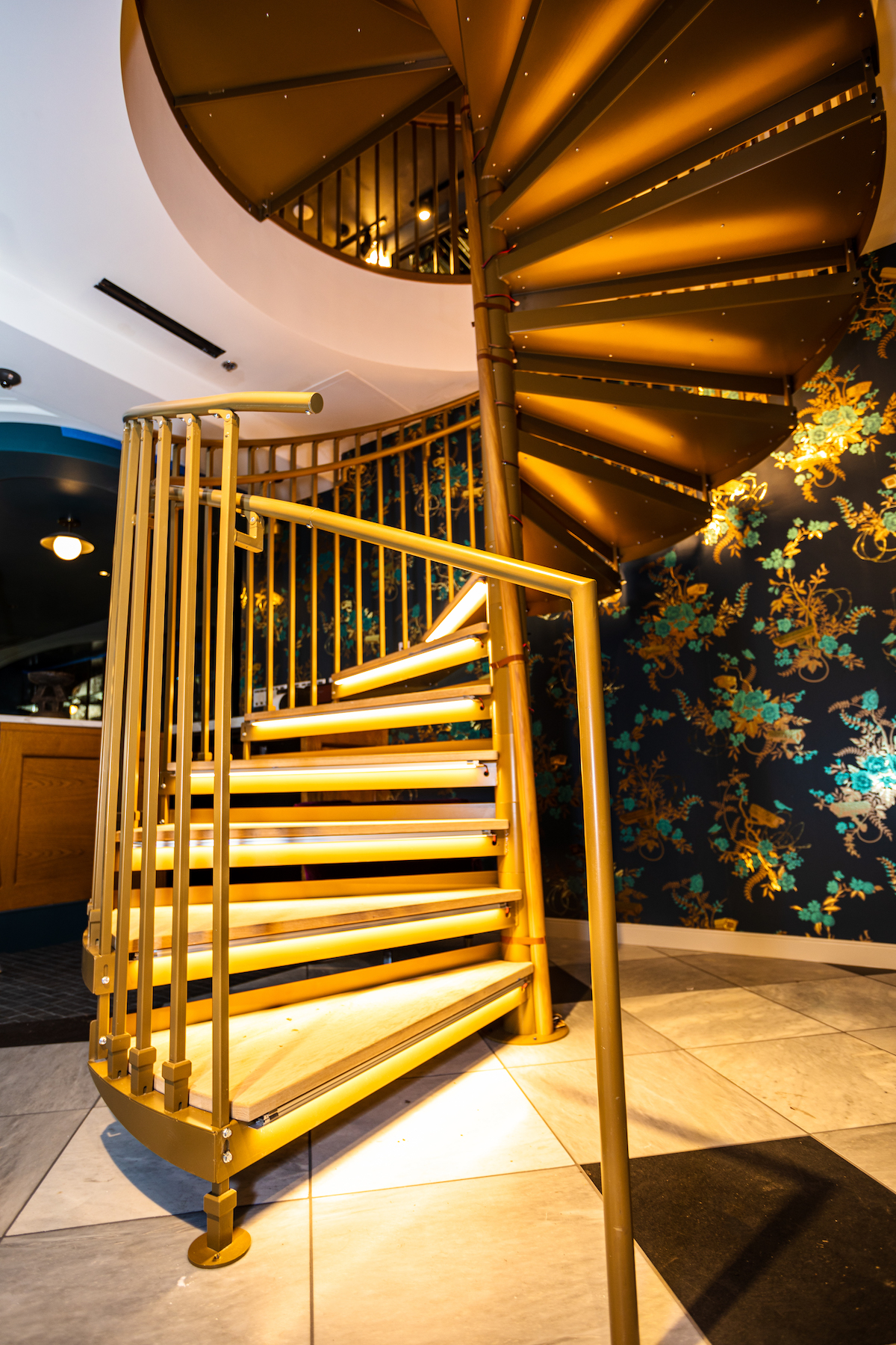 Winding stairs lead to a second-floor whiskey bar. 