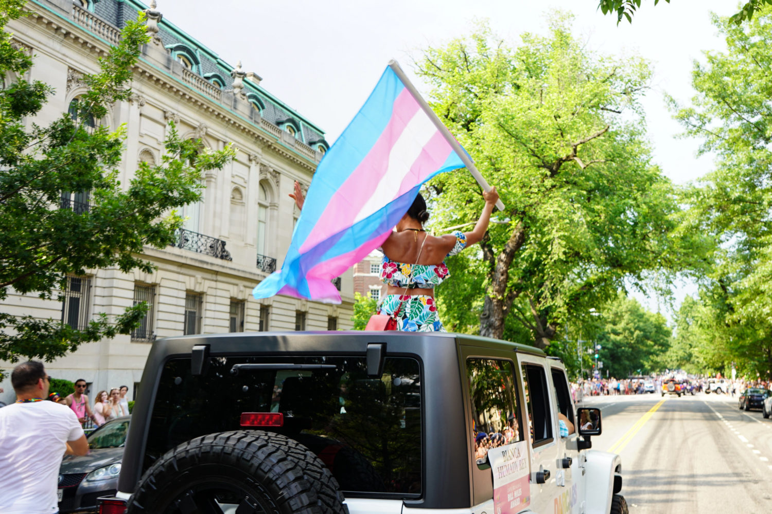 woman holding a trans flag