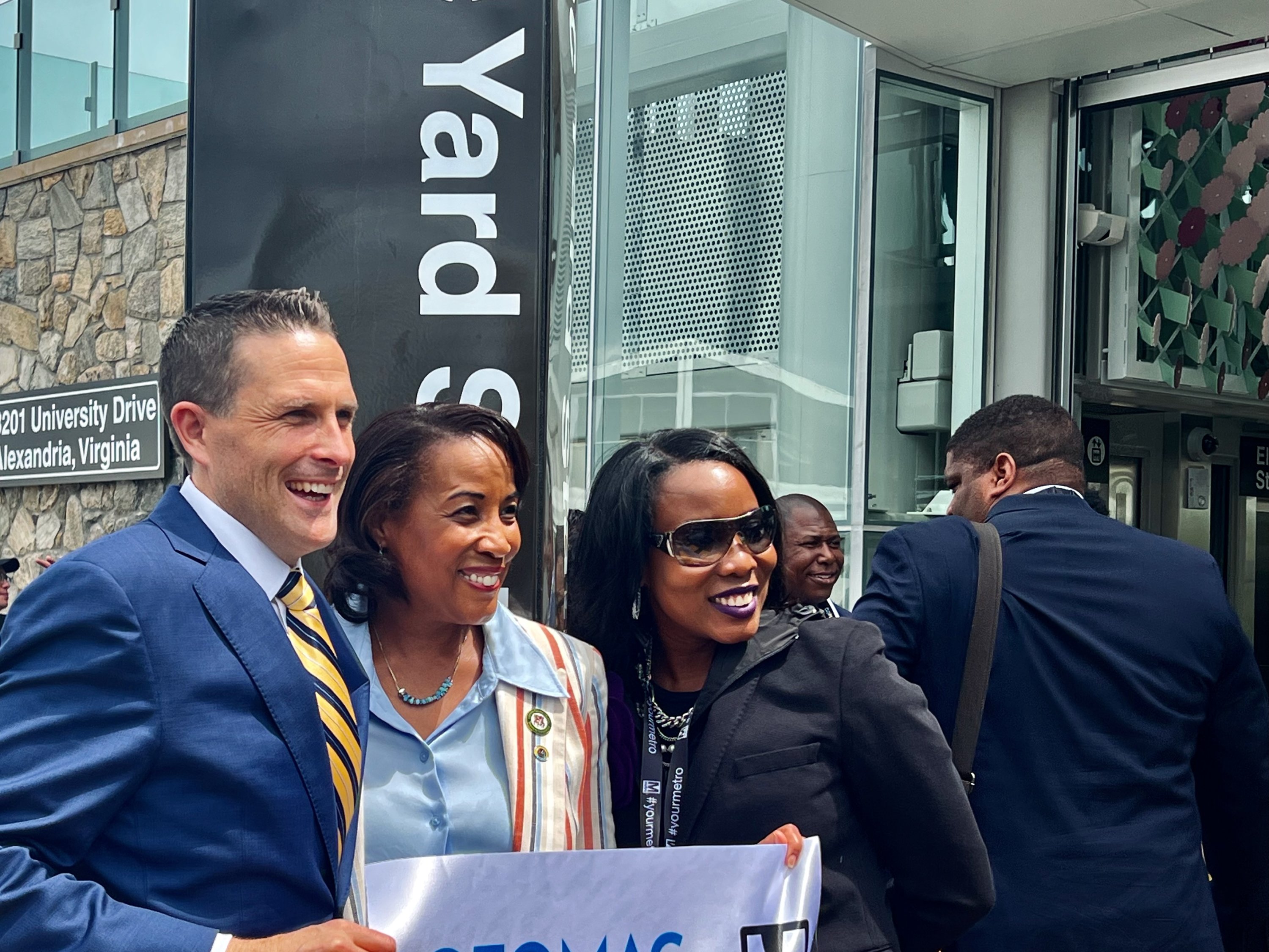 Clarke, Northern Virginia Transportation Authority Chair Phyllis Randall, and a guest celebrate the opening. 