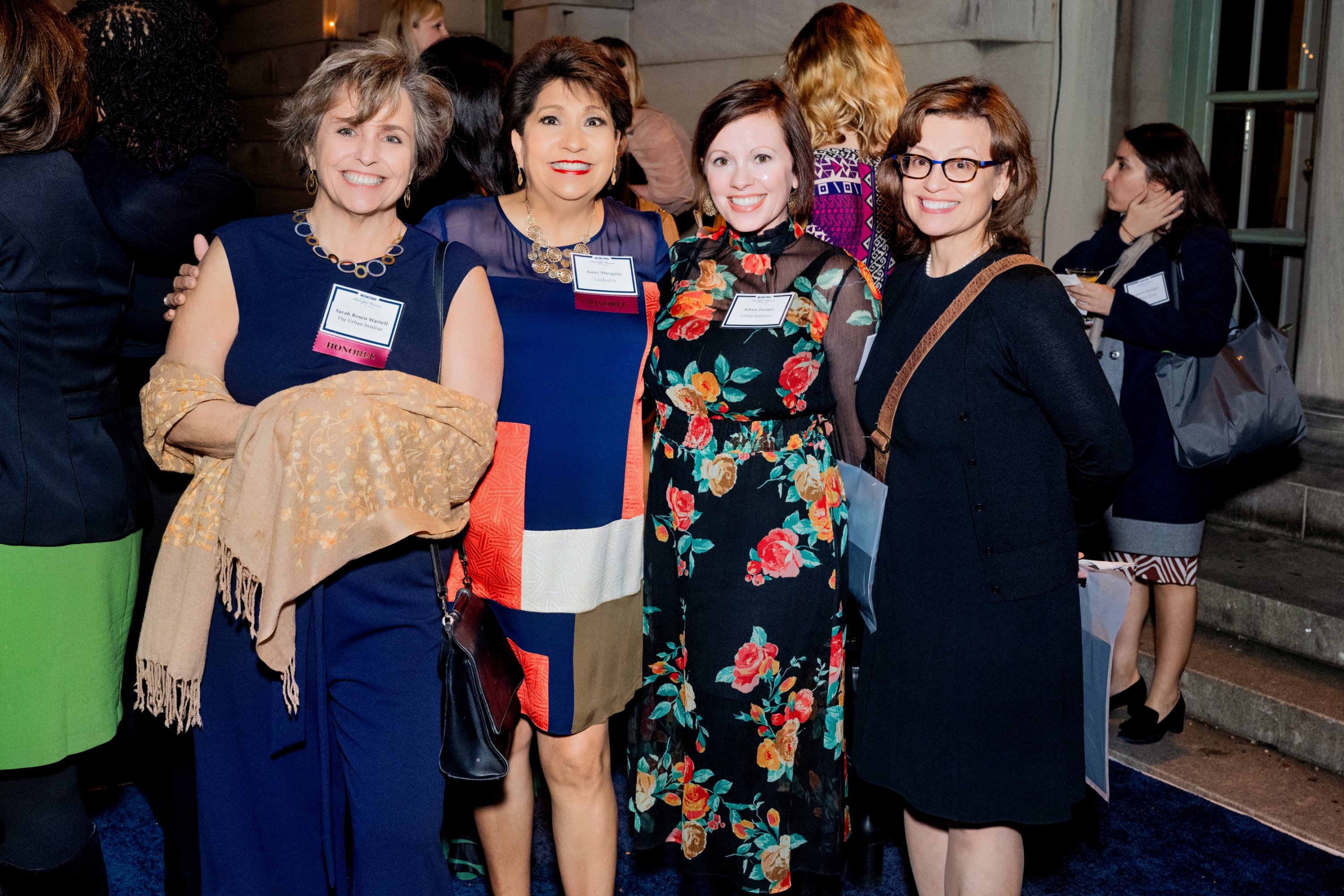 4 women in a group smiling for the camera