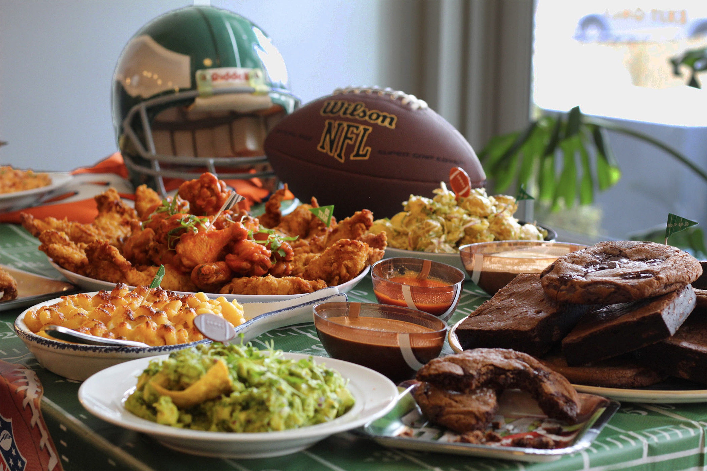 Photo of a Super Bowl spread of chicken wings, guacamole, etc.