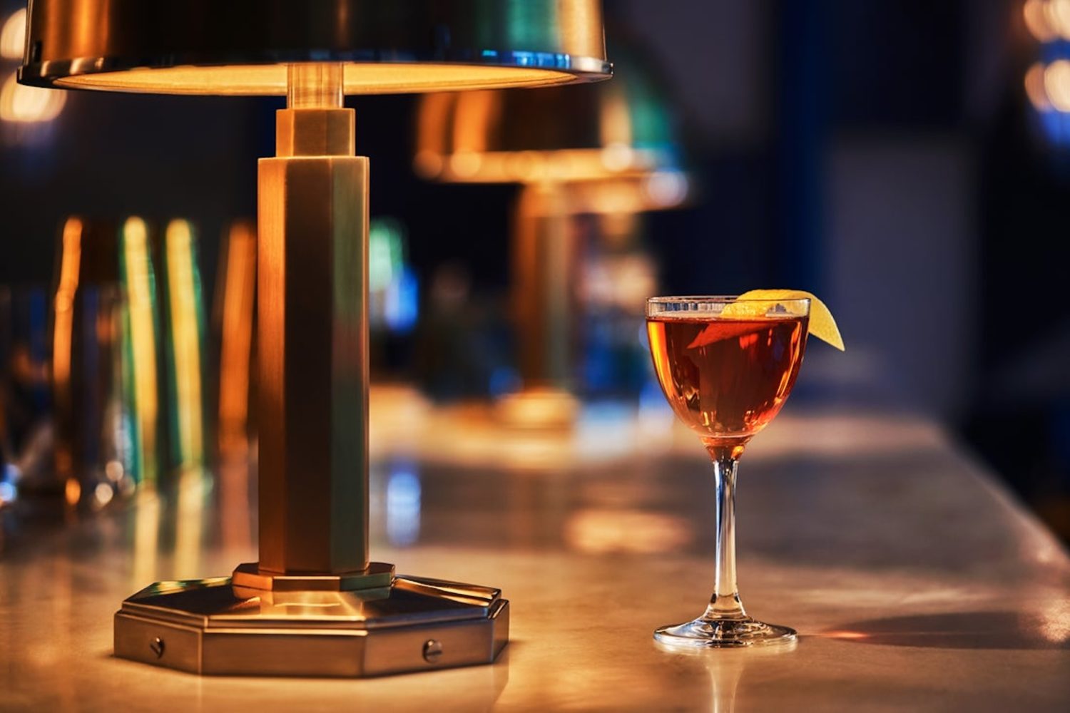 An image of a cocktail garnished with a lemon rind.