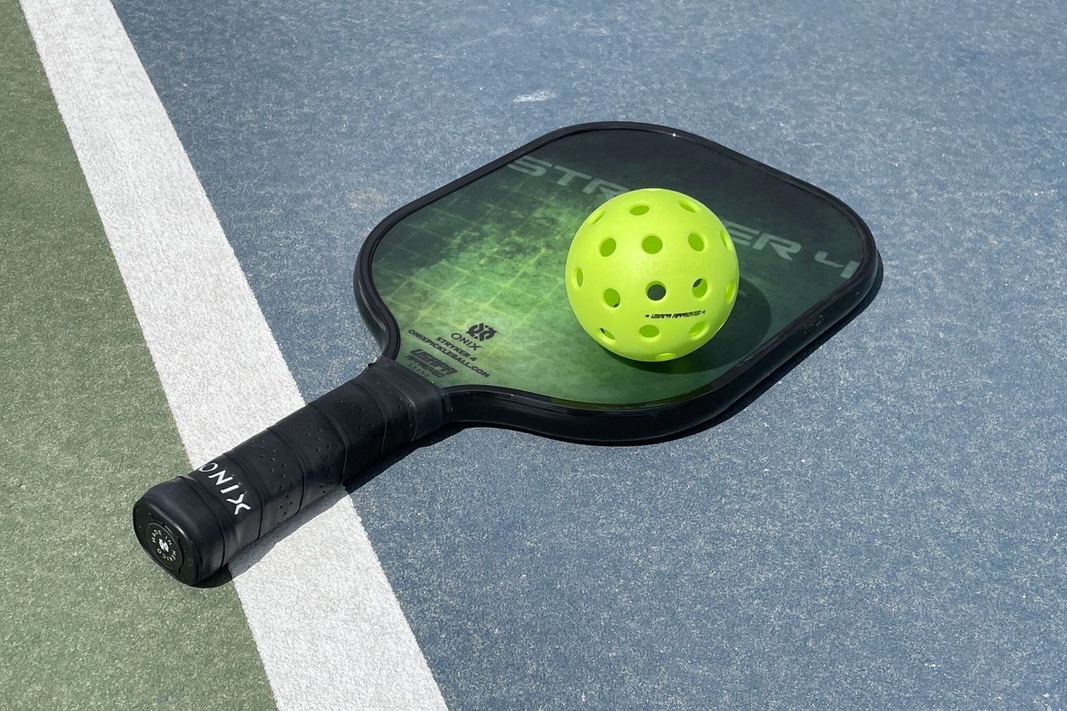 A pickleball racket on a court.