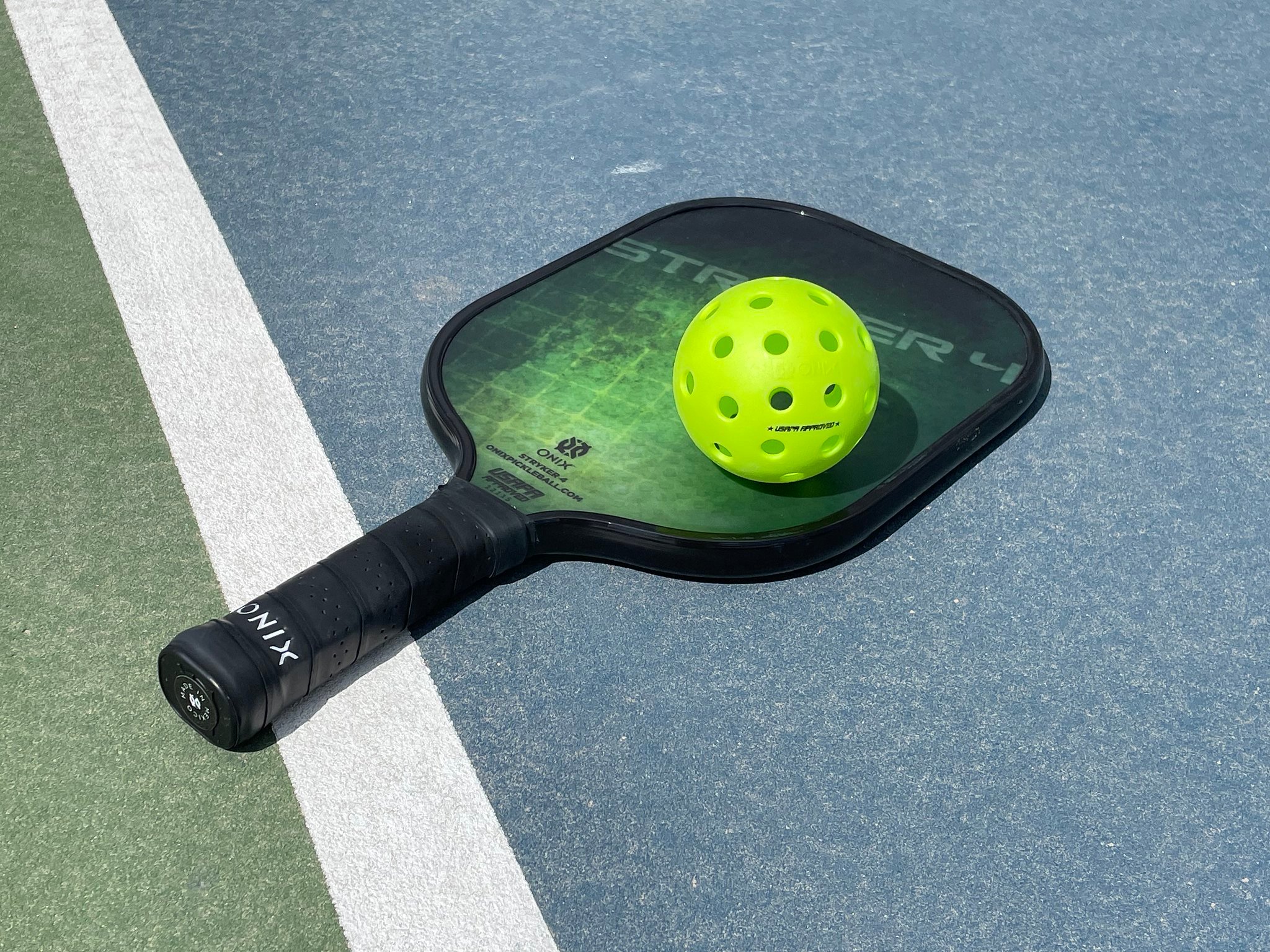 A pickleball racket on a court.