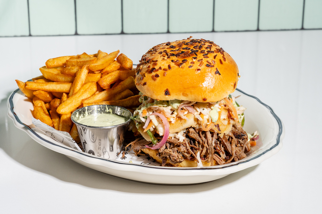 Silvie's Big Bun_Braised Brisket_cooked slow, Cheese Pupusa, Jalapeño Slaw & finished with Lime Crema on Onion Challah Bun_ Buffalo&Bergen_ClevelandPark_Birch Thomas - Washingtonian