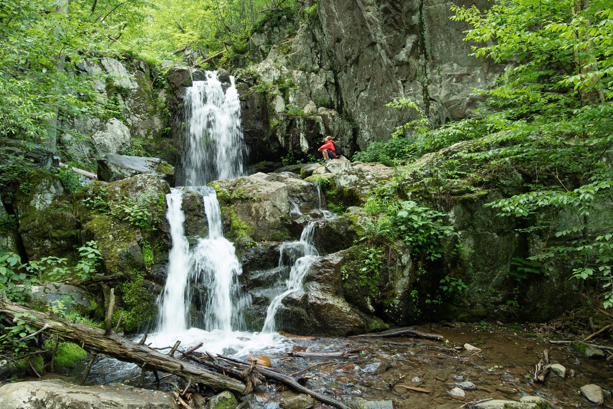 Man exploring Doyles river falls, Shenandoah National Park, Virginia, USA - Washingtonian